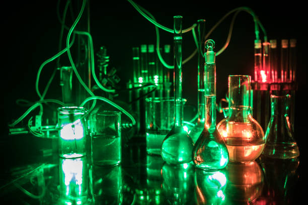 istock Pharmacy and chemistry theme. Test glass flask with solution in research laboratory. Science and medical background. Laboratory test tubes on dark toned background 1142577972