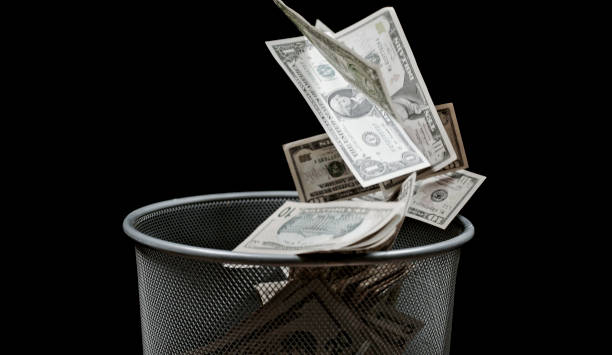 istock View of money falling into bin 1142578449