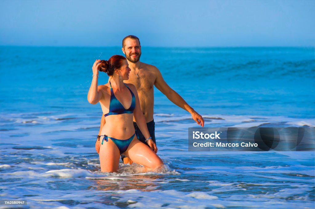 young happy and beautiful couple enjoying Summer holidays travel or honeymoon trip together in tropical paradise beach having fun relaxed and playful on the sea smiling cheerful 30-39 Years Stock Photo
