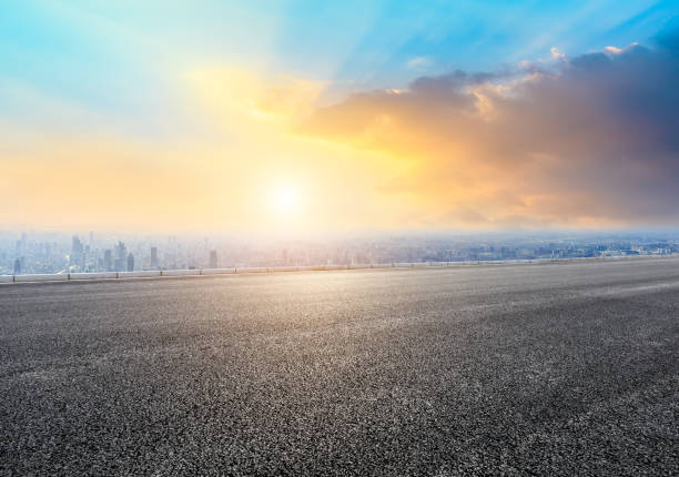 Shanghai city skyline and empty asphalt road scenery at sunrise