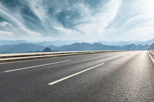 Empty asphalt road and mountains with beautiful clouds landscape