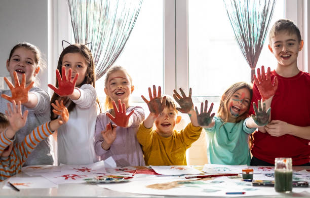 istock Group of children with painted hands 1142587810