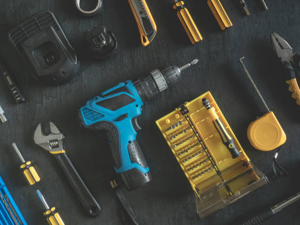 istock top view of Construction tools concept with Drill sets, hammer, screwdriver and Toolbox on black wooden background. 1142588479