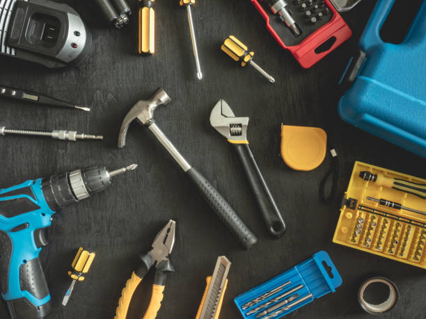 istock top view of Construction tools concept with Drill sets, hammer, screwdriver and Toolbox on black wooden background. 1142588517