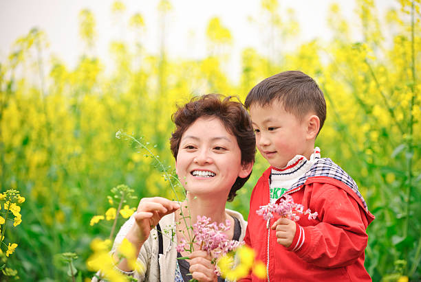 istock asian mother and son in flowers 114259353