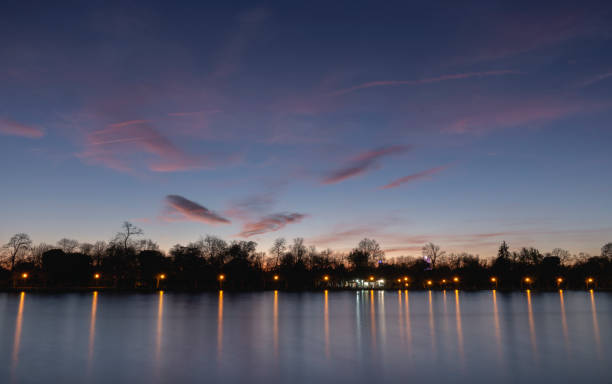 istock Pond of the Retiro park illuminated at sunset 1142596292