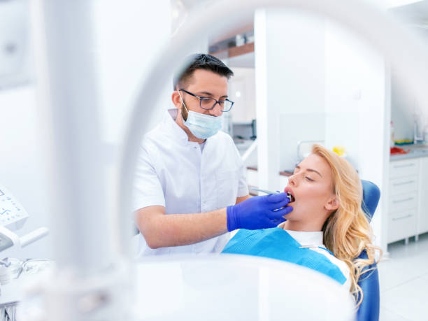 istock Dentists with a patient during a dental intervention 1142598798