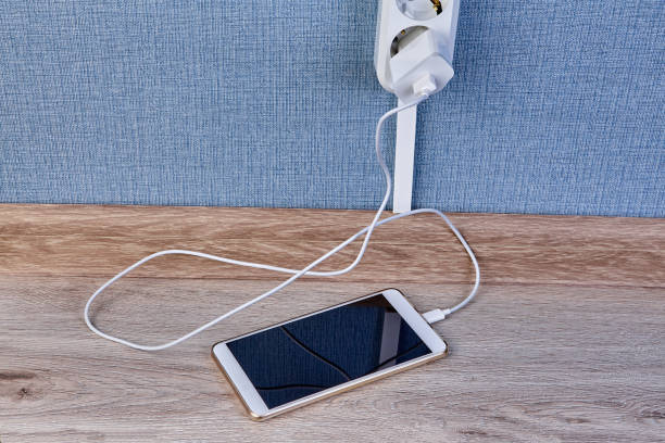 istock Smartphone is plugged into  charger and lie on floor. 1142601167