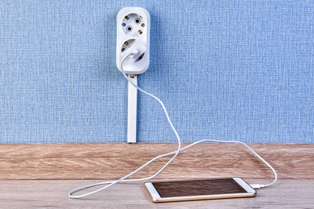 istock Mobile phone is charging with wall outlet. 1142601177