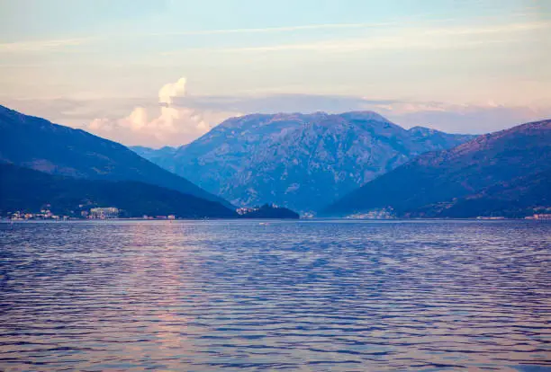 Photo of sea water surface and mountains