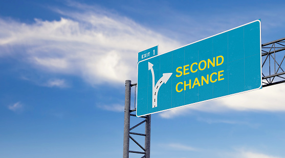 Large green - blue highway sign with text message about second chance and options