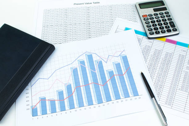 istock Financial printed paper charts, graphs and diagrams on the table. Top view 1142610621