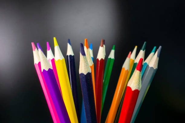 istock Coloured pencils arranged neatly in a black background 1142610968