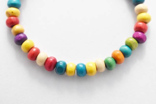 istock Wooden Beads Bracelet Rainbow on White Background 1142611929