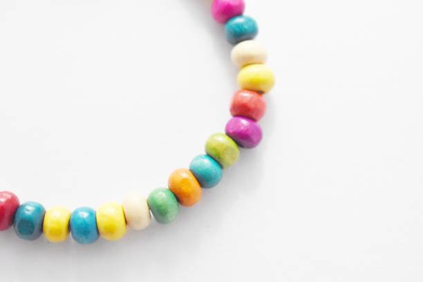 istock Wooden Beads Bracelet Rainbow on White Background 1142611931