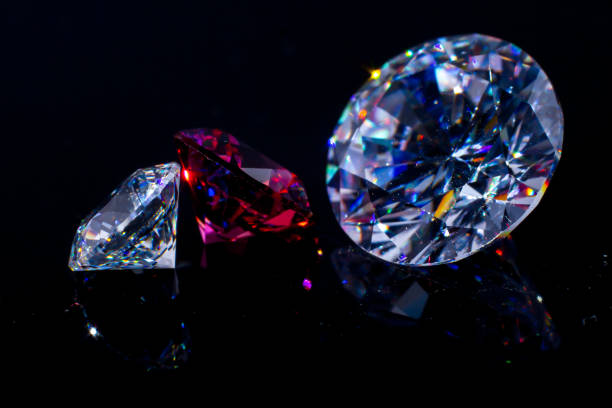 istock Several Swarovski chic crystals on a black mirror surface, shimmer and sparkle. 1142613343