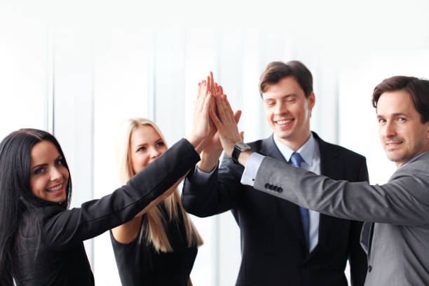 istock Business team giving high five in office 1142613408