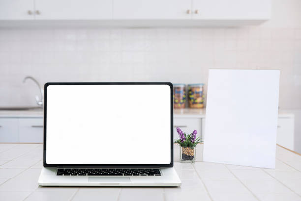 istock Mockup blank screen laptop and blank menu frame on white table in kitchen room. 1142614223