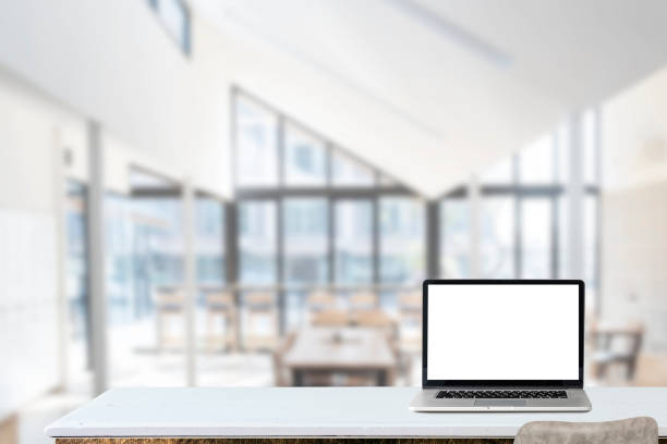 istock Mockup blank screen laptop on wood table in co-working space. 1142614753