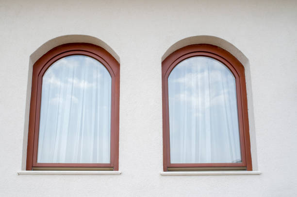 istock Two wooden arched windows with thin seamless curtain and reflection 1142616699
