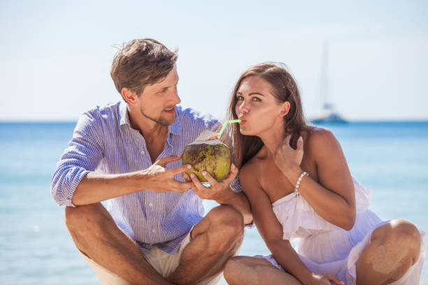 istock Couple drinking coconut cocktail 1142618200