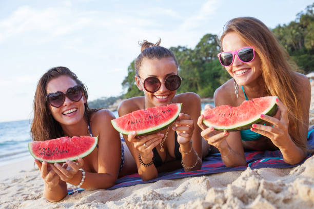 istock Female friends eating watermelon 1142618267