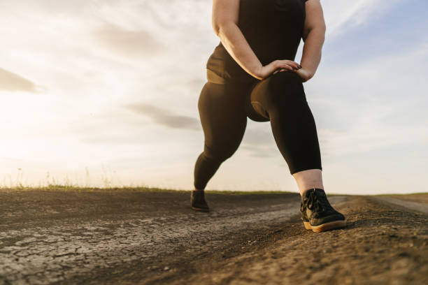 istock Woman warming up legs before outdoor running 1142619318