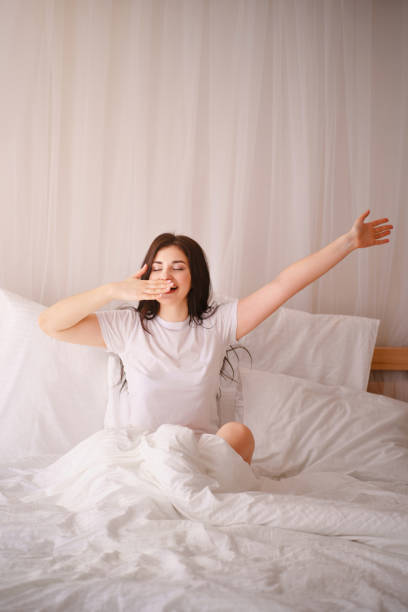 istock Happy woman waking up after good sleeping 1142619347