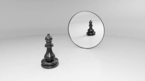 istock black bishop sees his broken reflection in the mirror 1142621252