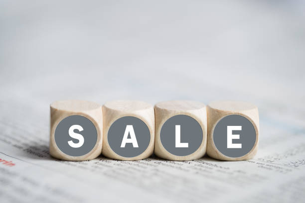 istock cubes forming the word sale on a newspaper 1142621272