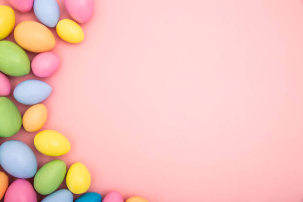 istock Colourful Easter eggs on a pink pastel background with copy space 1142621305