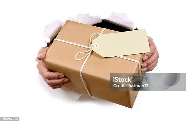 Brown Paper Package Bursting Through Background Stock Photo - Download Image Now - Gift Tag - Note, Giving, Torn