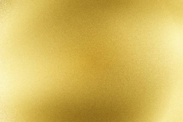 istock Abstract texture background, light shining on golden stainless sheet 1142623566