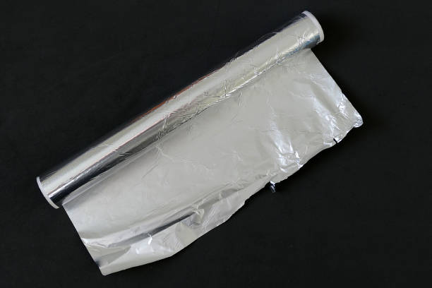 istock aluminum foil on black background, aluminum foil for baking 1142623939