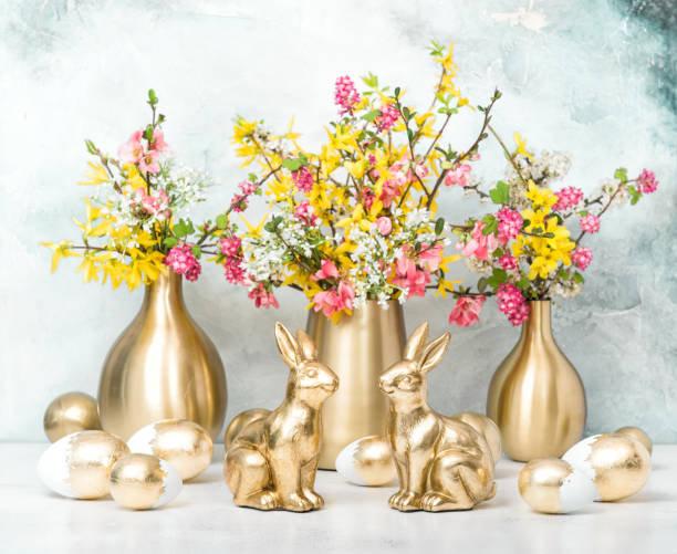 istock Easter bunnies golden eggs flower decoration 1142626381