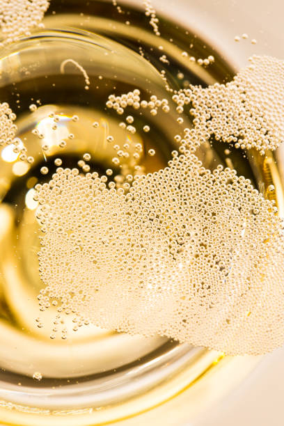Many small bubbles in a champagne glass stock photo