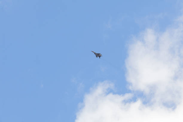 istock Military fighter in the blue sky with white clouds 1142628148