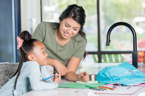 istock Nanny helping child with homework 1142630039
