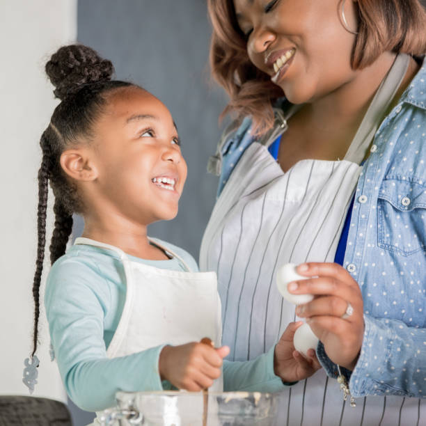 istock Mother and daughter baking together 1142630067