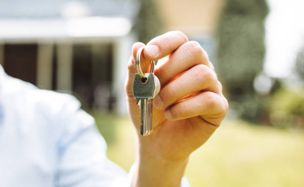 istock owner with house key close up 1142631667