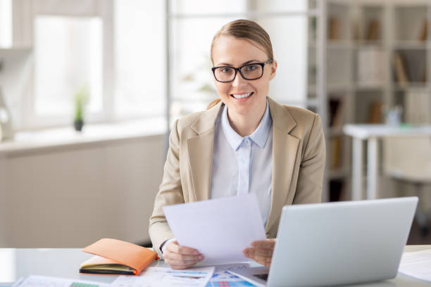 istock Cheerful financial employee examining report 1142632550