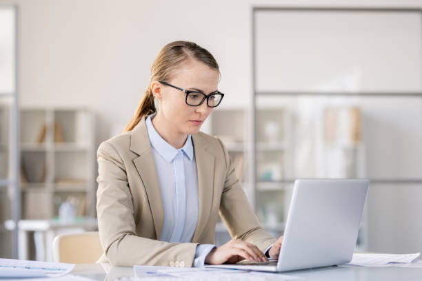istock Busy woman preparing presentation on laptop 1142632564