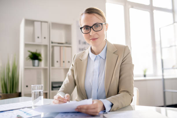 istock Attractive office specialist working with report 1142632568