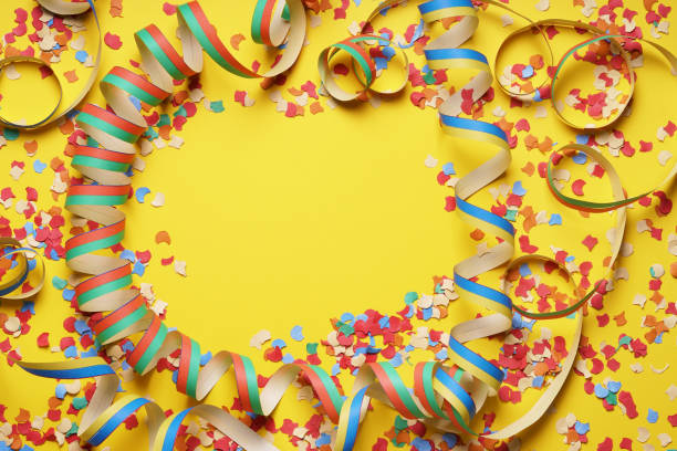 istock confetti and paper streamer frame on yellow background 1142632613