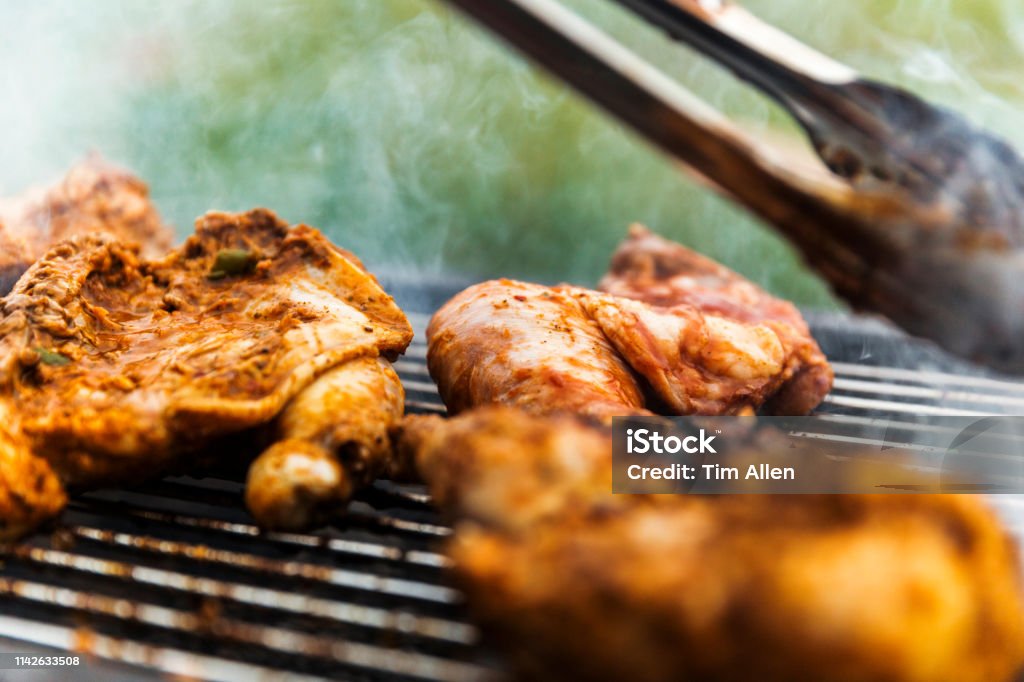 Home Cook Checking Each Marinated Barbecue Chicken Piece Carefully Home cook checking each marinated barbecue chicken piece carefully. Agriculture Stock Photo