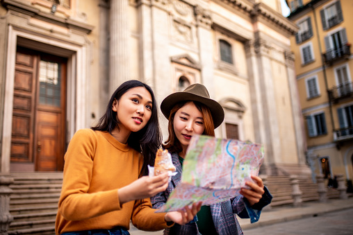 Two smiling Asian girls visiting Italy.