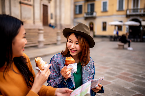 Two smiling Asian girls visiting Italy.