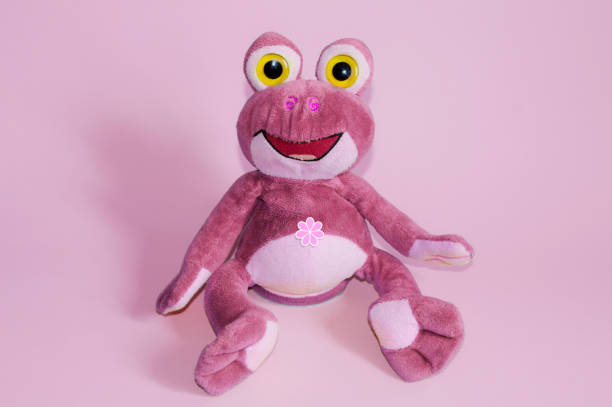 istock Toy soft cheerful pink frog on a pink background 1142636748