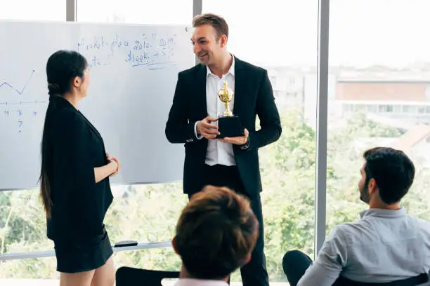 Photo of Boss awarding workers during conference