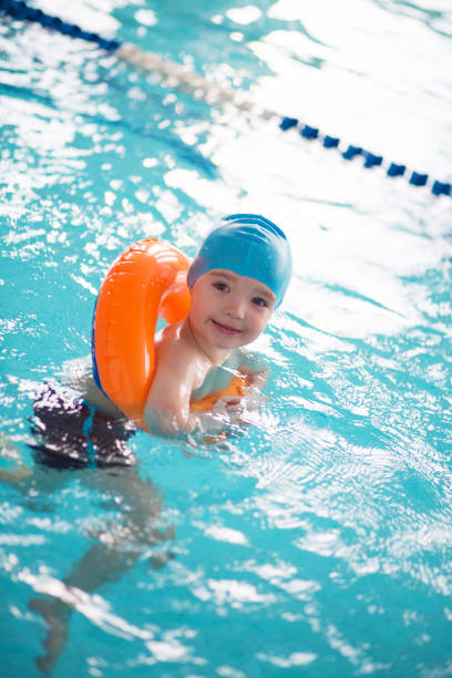 istock Baby boy learns to swim in the pool 1142637535